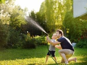 Father and Son Watering the lawn