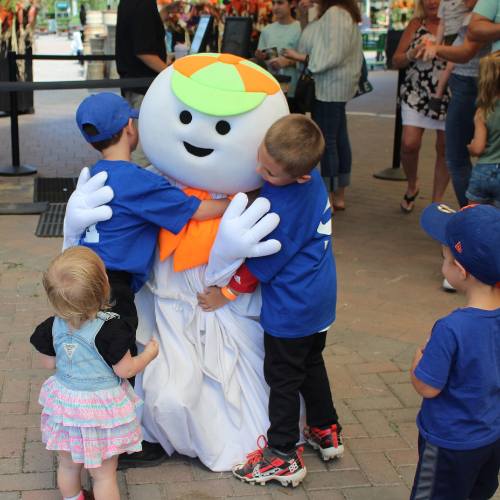 Hicks Nurseries Fall Festival (10) A group of kids hugging a person in a garment.
